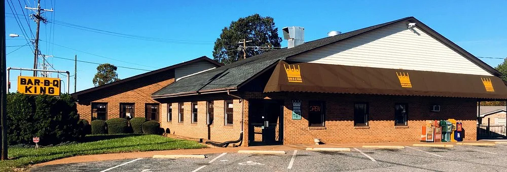 Bar-B-Q King restaurant exterior showing the brick storefront and crown-logo awning